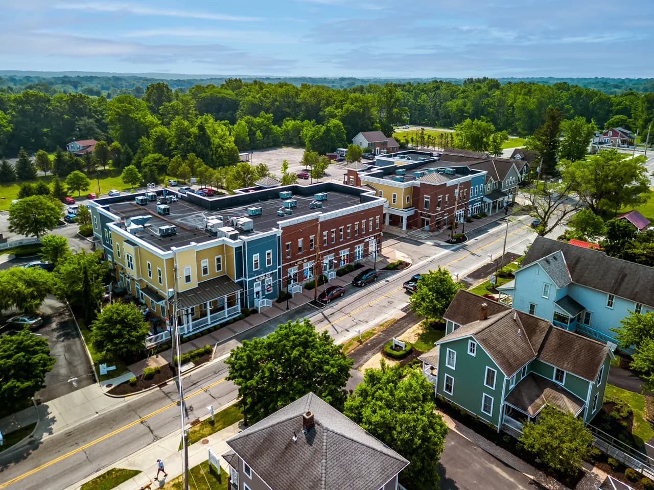 Aerial view of a small-town main street lined with shops and houses