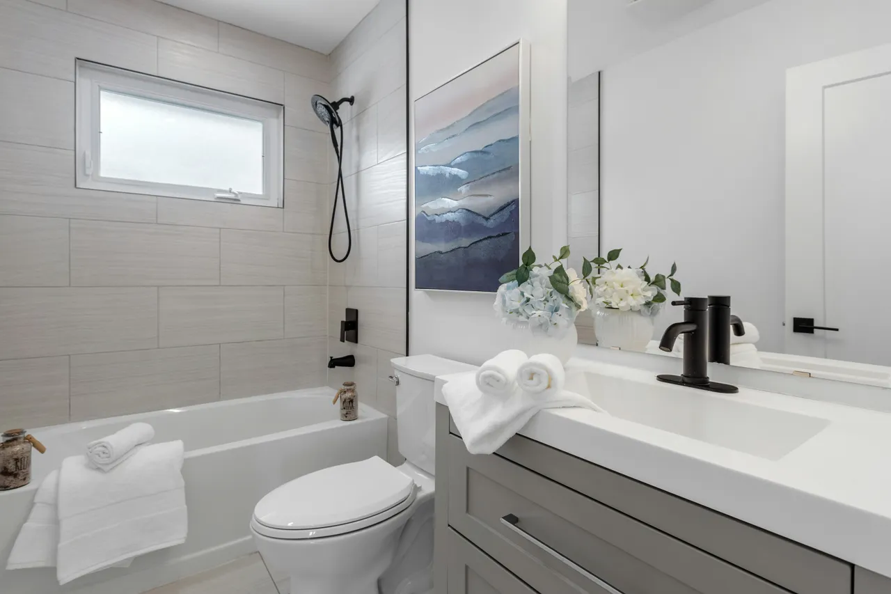 Finished bathroom with a vanity, tub and toilet